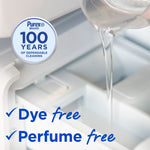 Close-up of clear liquid being poured into a washing machine drawer with Purex 100 years badge and dye/perfume free text