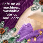 Top-down styled shot of purple knitwear and pillow with text stating safety on all machines and washable fabrics, with pine accents.