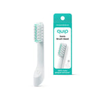 Single Quip sonic replacement brush head shown upright next to its teal-accented retail box on a white background.