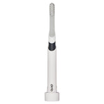 Quip charcoal toothbrush inserted into white cylindrical travel stand showing brush head and handle