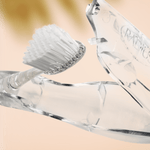 Close-up macro of a Radius Tour toothbrush head and part of the transparent hide-away handle against a soft background