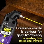 Close-up of Raid Max spray nozzle inserted into a wooden drawer demonstrating precision nozzle for spot treatment
