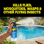 Hand spraying a Raid Flying Insect can near a backyard pool, with bold text 'Kills flies, mosquitoes, wasps & other flying insects'.