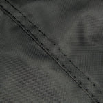 Detailed close-up of dark woven fabric and reinforced seam stitching on a protective cover