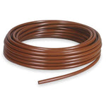Coiled brown irrigation tubing displayed on a white background, showing a smooth round cross-section and loose tail end.