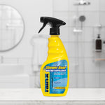 Yellow Rain‑X Shower Door Water Repellent bottle placed on a bathroom counter with blurred shower in the background.