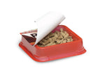 Open red bait tray filled with pellet-style bait and partially peeled label showing RatX branding