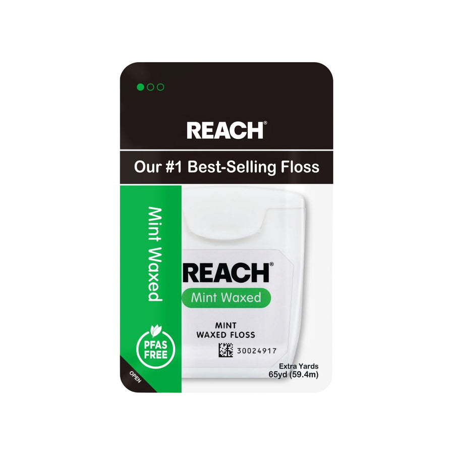 REACH Mint Waxed dental floss package with white floss dispenser and green branding on retail card.