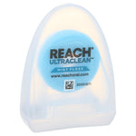 Close-up of a translucent REACH Ultraclean mint floss plastic dispenser showing internal spool and logo