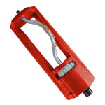 Red plastic oscillating lawn sprinkler body with metal curved spray bar and adjustment dial on white background