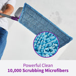 Close-up angled view of a blue microfiber mop pad attached to a purple mop head with magnified fiber detail.