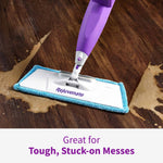 Rejuvenate mop gliding over dark wood floor removing stuck-on messes with splashed liquid visible