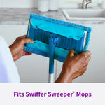 Hands fitting a blue Rejuvenate microfiber pad onto a rectangular mop head in a kitchen setting, highlighting attachment.