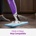 Purple Rejuvenate spray mop in use on a dark floor with blue microfiber pad and visible spray mist from the handle.