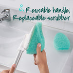 Close-up of a hand removing a green non‑scratch scrubber pad from a white scrubber head on a gray extendable handle.