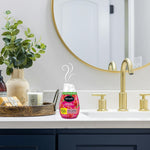 Renuzit Forever Raspberry gel air freshener placed on a bathroom countertop beside decor items with scent swirls rising above the bottle