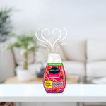 Renuzit Forever Raspberry gel air freshener placed on a white surface with stylized scent swirls and blurred living room background