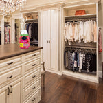 Renuzit Forever Raspberry gel air freshener shown on a dresser island inside a walk-in closet with scent swirls added above the bottle