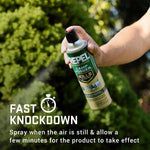 Person's hand spraying a Repel Camp Fogger can with fast knockdown caption and stopwatch icon over a leafy background