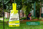Hanging RESCUE! Japanese Beetle Trap refill bag displayed outdoors on a shepherd's hook with yard scene and overlay text