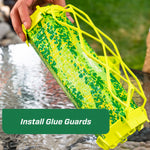 Person holding a TrapStik while installing bright green plastic glue guards over the adhesive surface