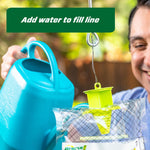 Add water to the clear RESCUE! Yellowjacket Trap showing the green funnel top and fill line with watering can