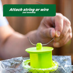 Close-up of hands attaching string or wire to the green hanging loop on top of the RESCUE! Yellowjacket Trap