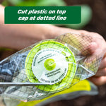 Close-up of hands cutting top cap of trap packaging at dotted line with text overlay instruction