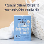 Lifestyle shot of re·stor baby laundry detergent box beside white linens and basket with headline about plastic waste