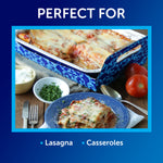 Promotional image showing a lasagna in a Reynolds aluminum pan inside a decorative carrier with caption listing ‘Perfect for’ lasagna and casseroles