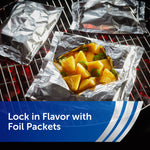 Foil packets on a grill with one packet opened to reveal pineapple pieces, illustrating foil packet cooking