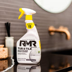 RMR Tub & Tile spray bottle placed on a glossy bathroom counter with blurred faucet and mirror in background