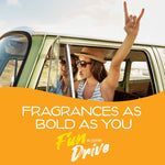 Two people enjoying a road trip in a vintage van with one raising a hand, over an orange panel reading Fragrances As Bold As You.