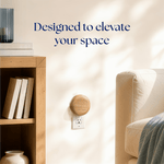 Room scene showing a wood-grain Scent Theory plug-in diffuser on a wall outlet beside shelving and a sofa with headline 'Designed to elevate your space'
