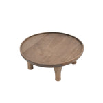 Angled top view of a round wooden plant stand with raised rim and four short legs on white background