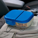 Blue Rubbermaid bento box closed on a backpack in a car interior, visible sandwich inside