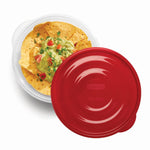 Overhead view of a clear bowl with chips and guacamole and a red Rubbermaid lid partially covering it