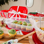 Tabletop display of Rubbermaid clear containers with red lids holding cupcakes and pasta, one lid tied as a gift