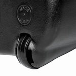 Close-up of a black dust pan corner showing a wheel detail and an embossed "Made in USA" mark on textured plastic.