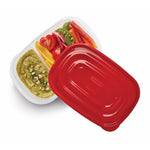 Overhead angled view of a Rubbermaid divided container with red lid partially removed showing vegetables and dip