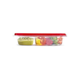 Side profile of a Rubbermaid divided container with red lid filled with colorful veggies and dip visible inside