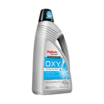 Front three-quarter view of a silver Rug Doctor Bissell OXY carpet and upholstery cleaner bottle with blue label