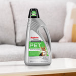 Rug Doctor Bissell PET stain and odor cleaner bottle staged on a table in a living room setting with sofa background