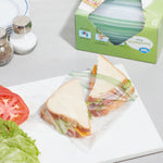Two sandwich halves sealed inside a clear Great Value sandwich bag with a box of sandwich bags in the background