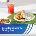 Served sandwich partially wrapped in aluminum foil on a plate with fries and salad, styled for serving or storing food