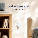 Lifestyle scene with a Scent Theory white plug-in diffuser in a living room outlet under soft sunlight and styling text