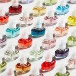 Close-up grid of multiple Yankee Candle ScentPlug refill bottles in assorted colors on white background