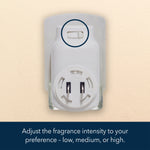Close-up of a white plug-in diffuser showing a small slider control circled above, mounted in a wall outlet on a beige background.