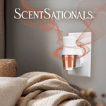 ScentSationals wall plug-in heater inserted in an outlet with an amber Feelin' Cozy refill installed and decorative aroma swirls around it.