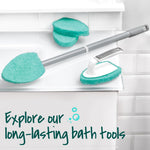 Assortment of Scotch‑Brite bath tools arranged on a ledge: extendable handle with pad, extra pads, and a handheld scrubber.